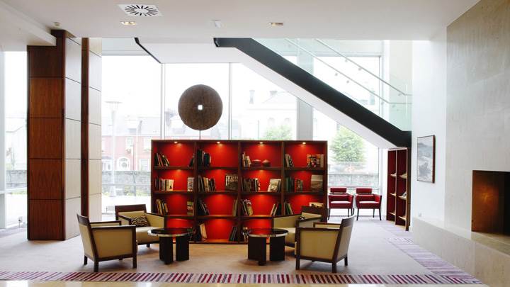 Books Shelves in Rack Near Chairs And Tables
